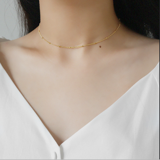 minimalist gold small bead choker necklace model view